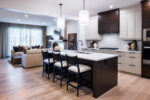 Luxury move-up show home kitchen with quartz countertops, island, and stainless steel appliances